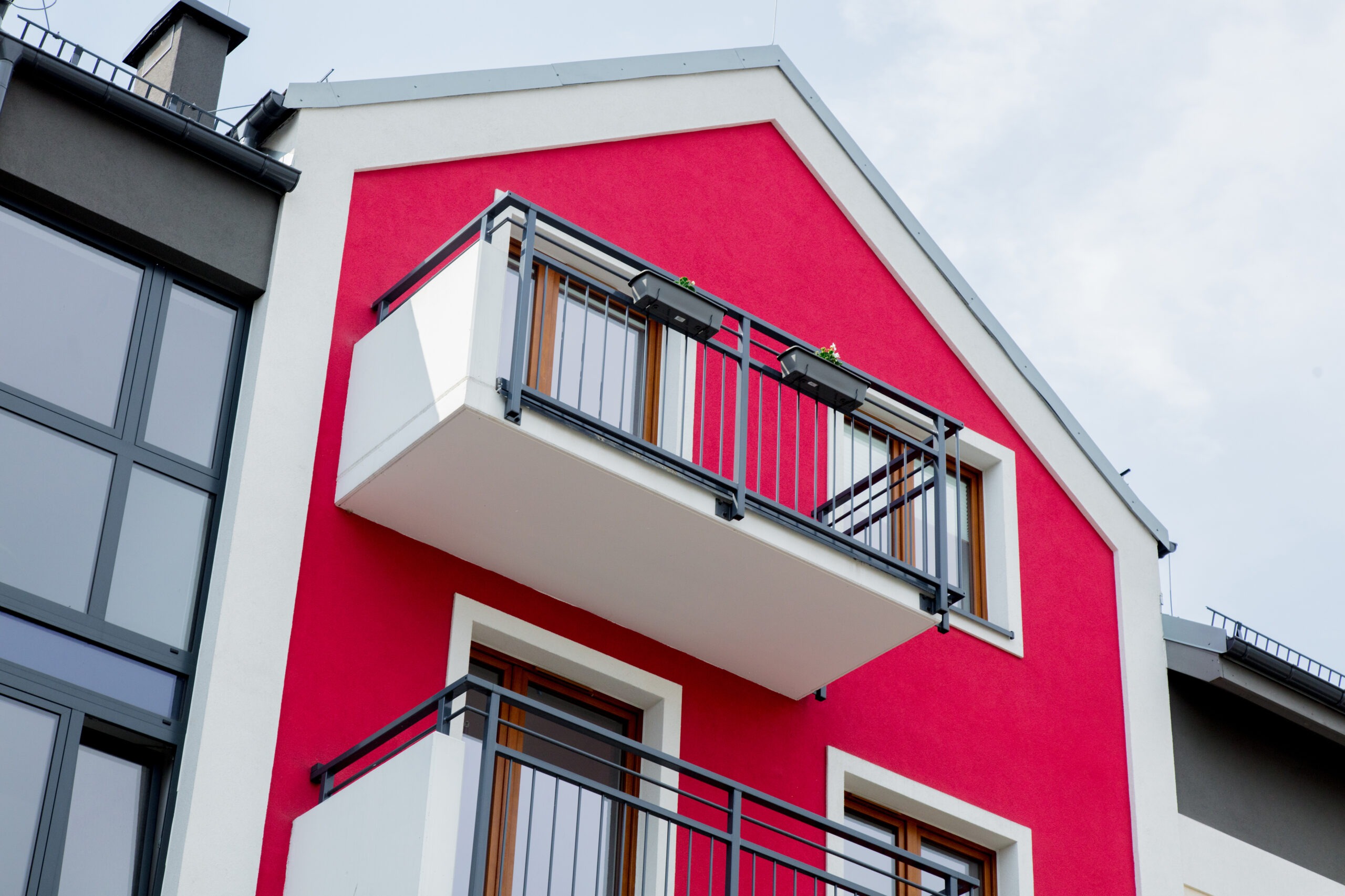 Red house with balcony. Servicios de pintura y aislamiento